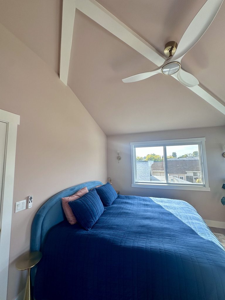 Bedroom with asymmetrical vaulted ceiling