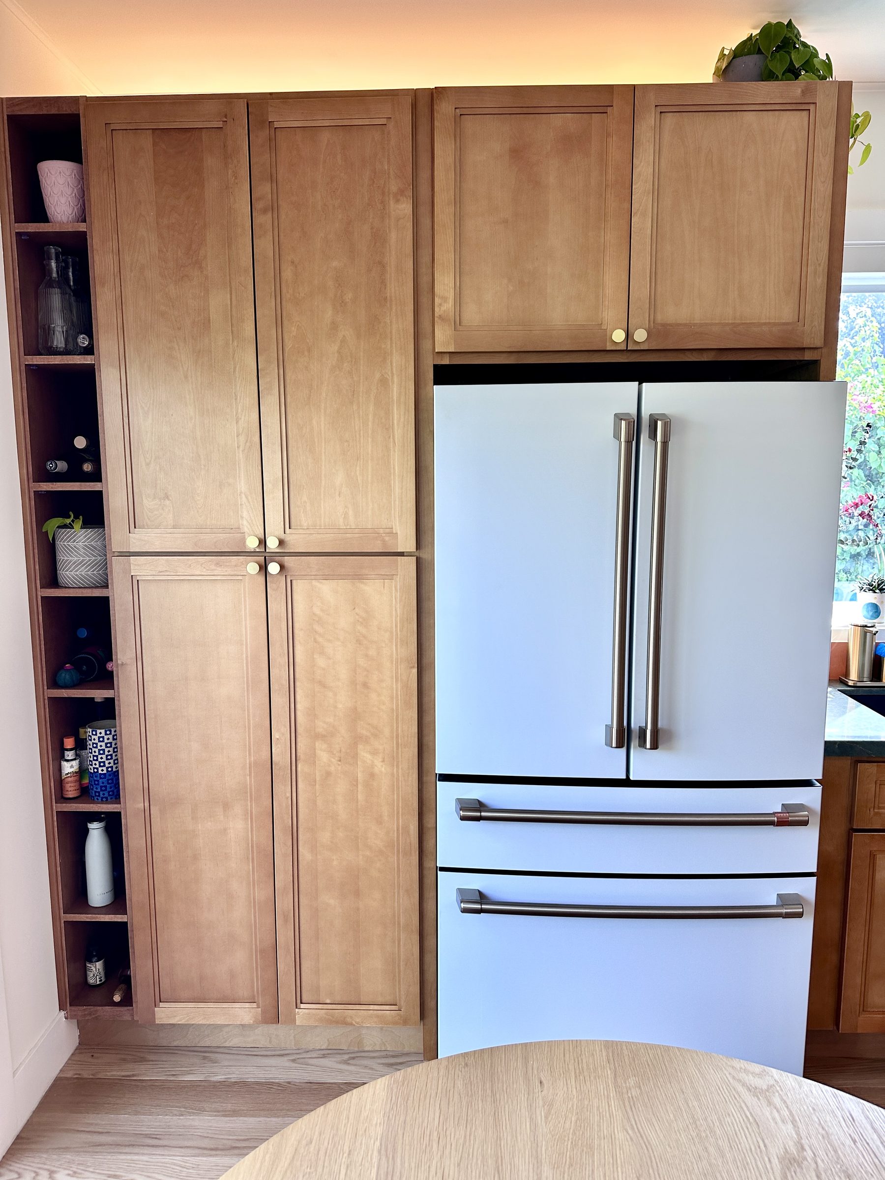 Custom cabinet surround with integrated white Café fridge