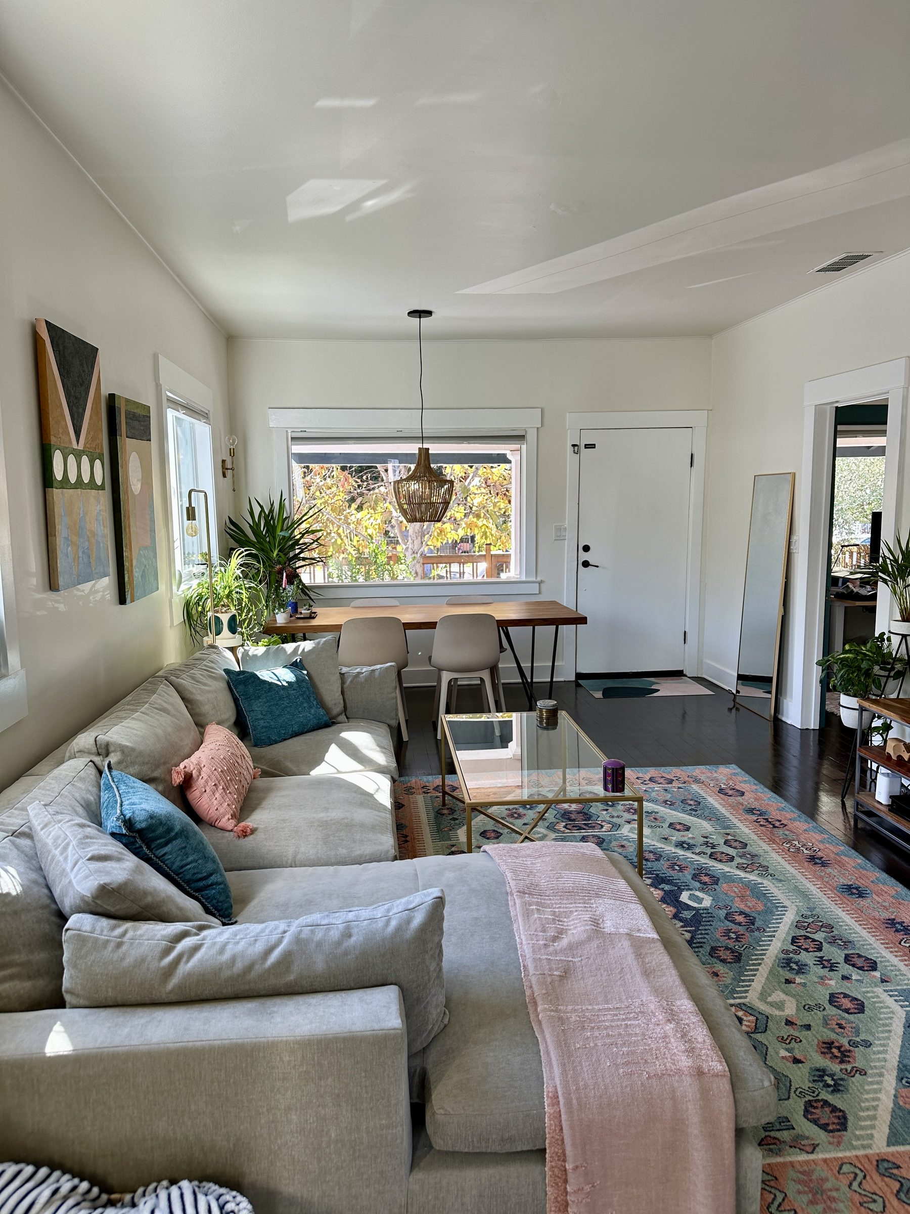 Original living room with dining table squeezed between sofa and front door