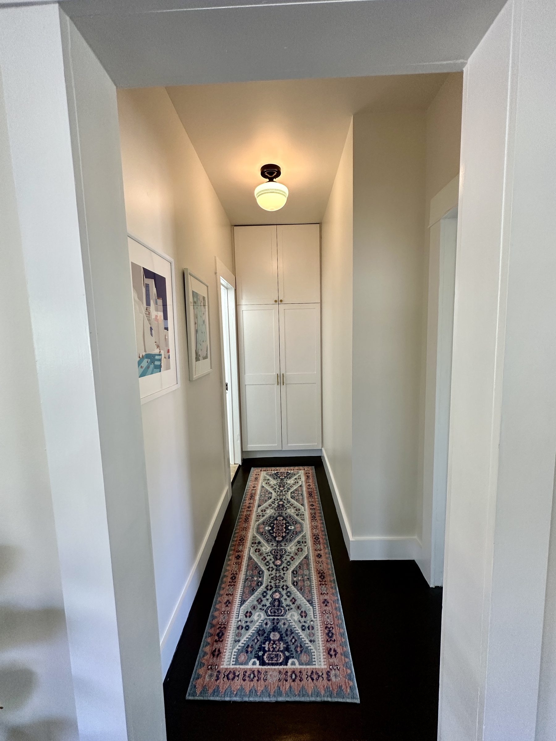 Original narrow hallway with dark floors
