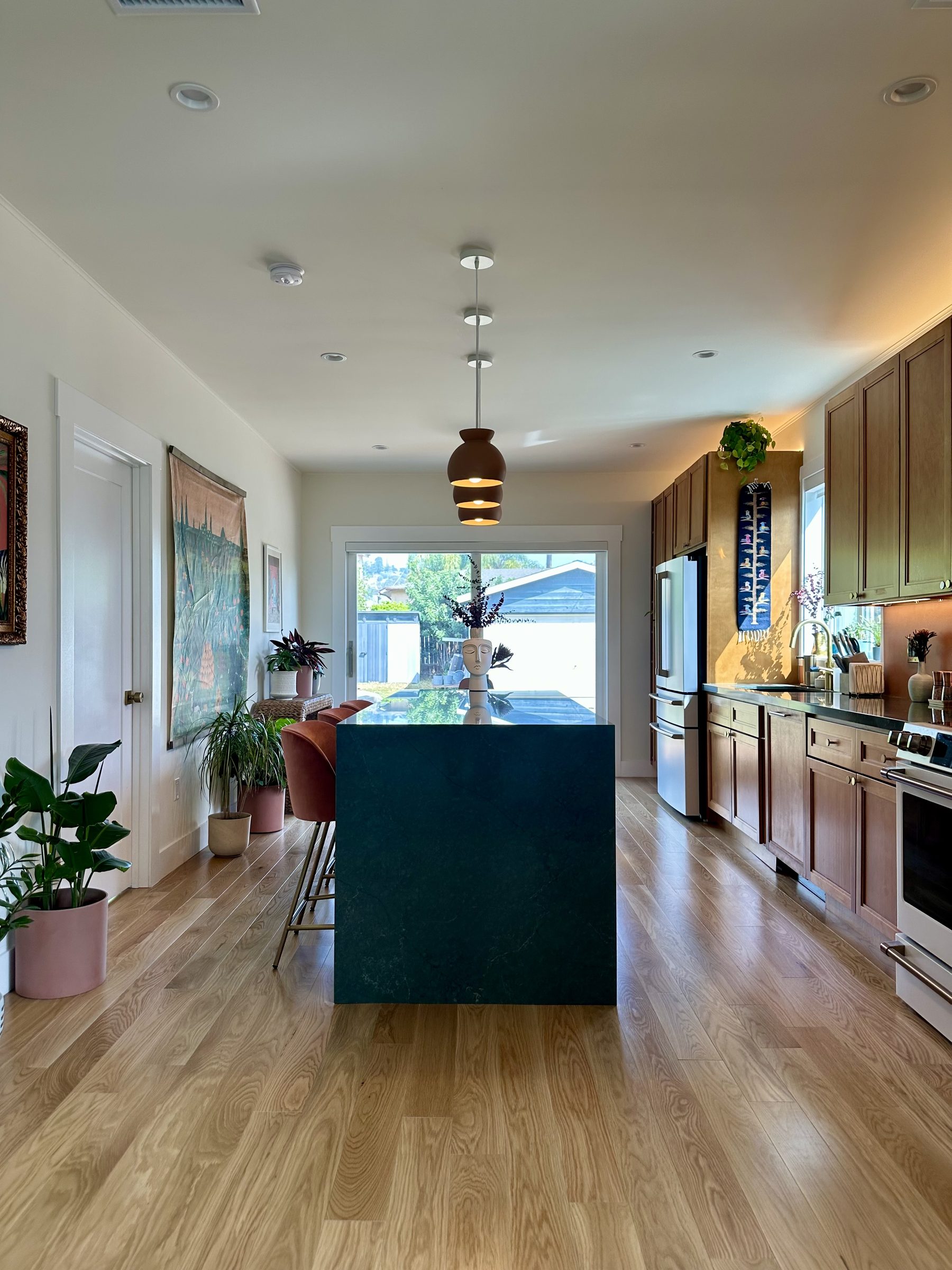 Renovated kitchen with green quartz island