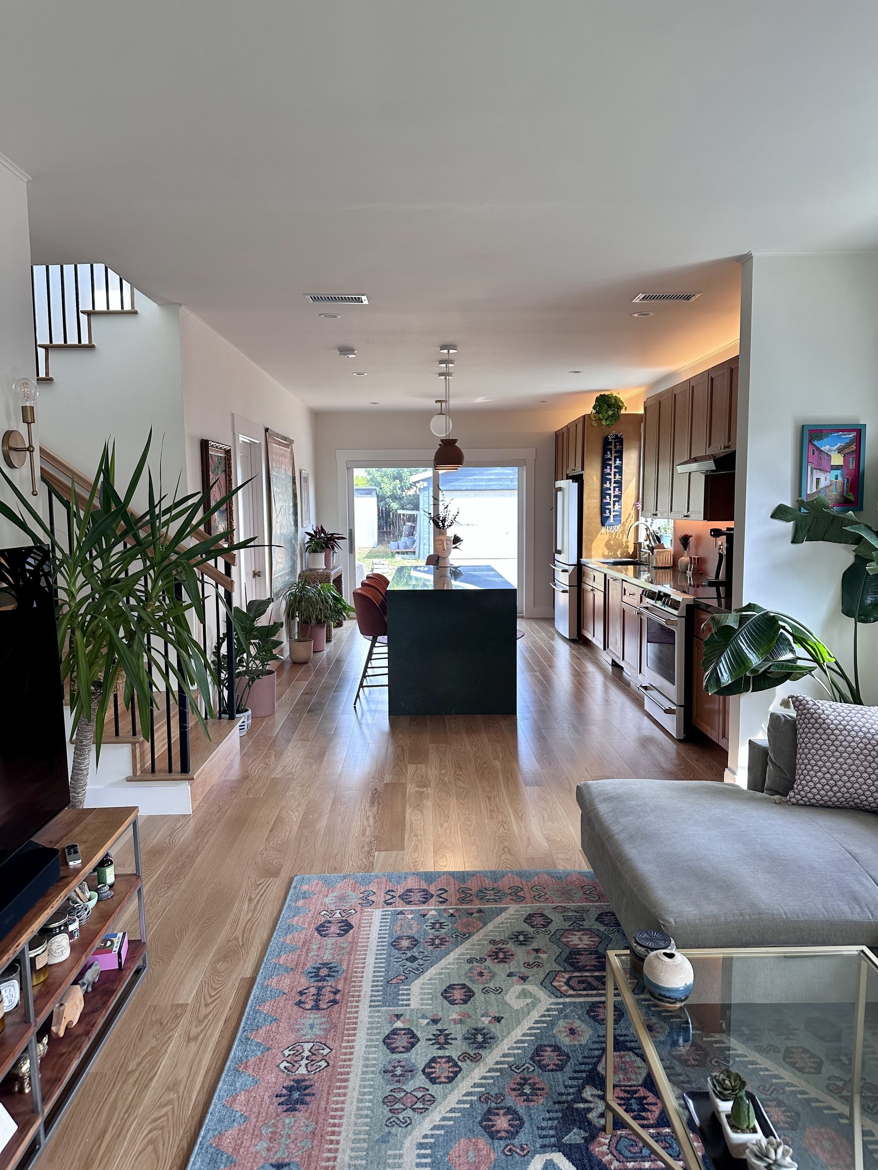 Same angle after renovation showing open plan through to kitchen and backyard