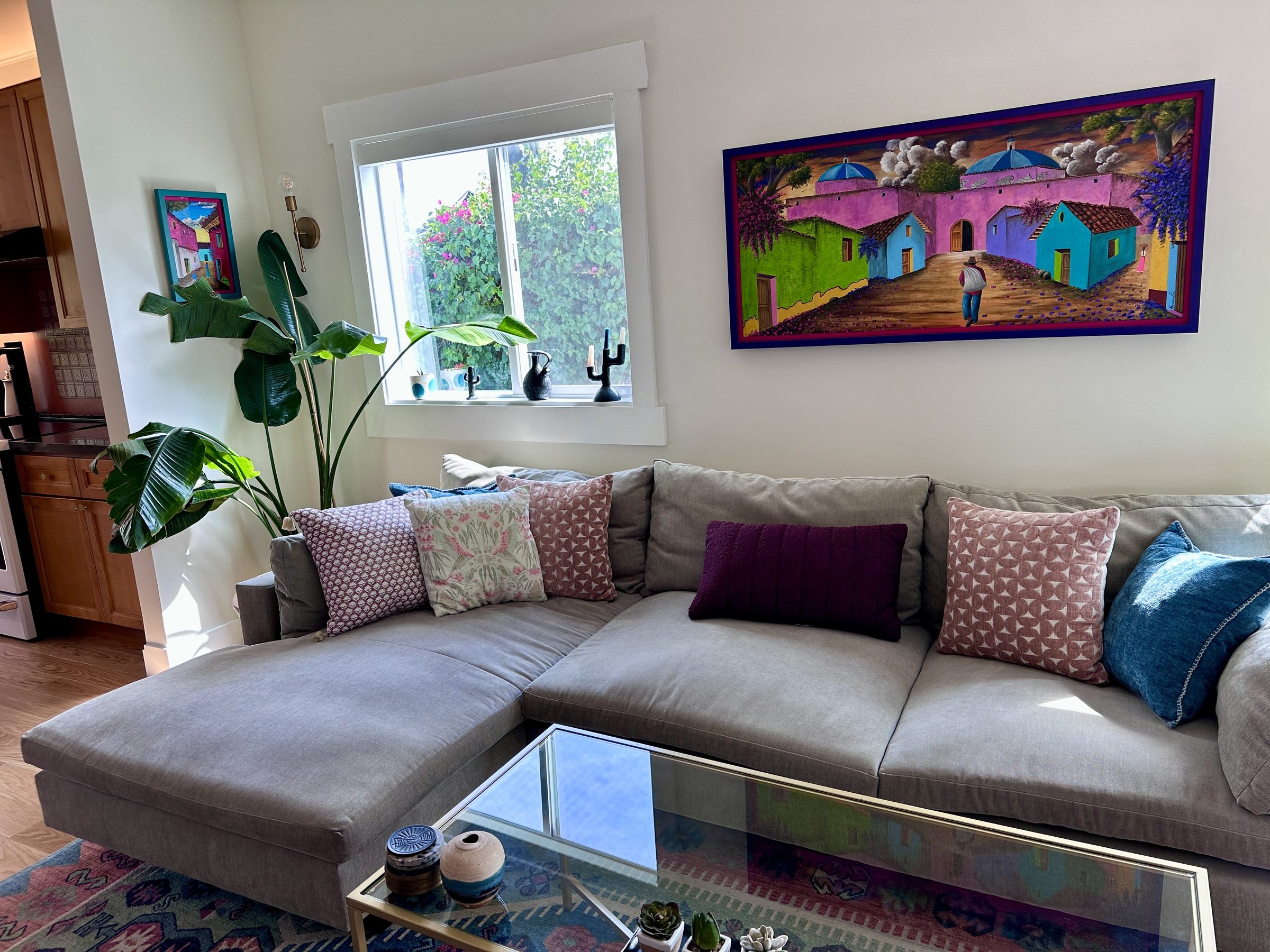 Sectional sofa with colorful art on the wall