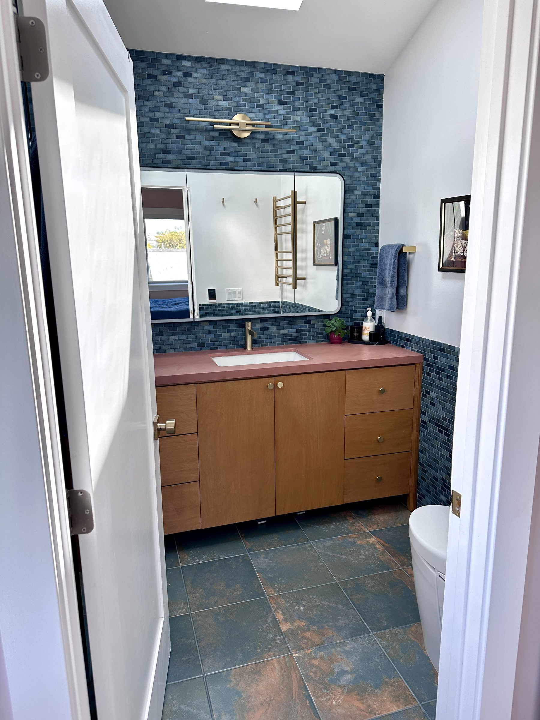 Upstairs bathroom with blue tile, Dekton counter, and birch vanity